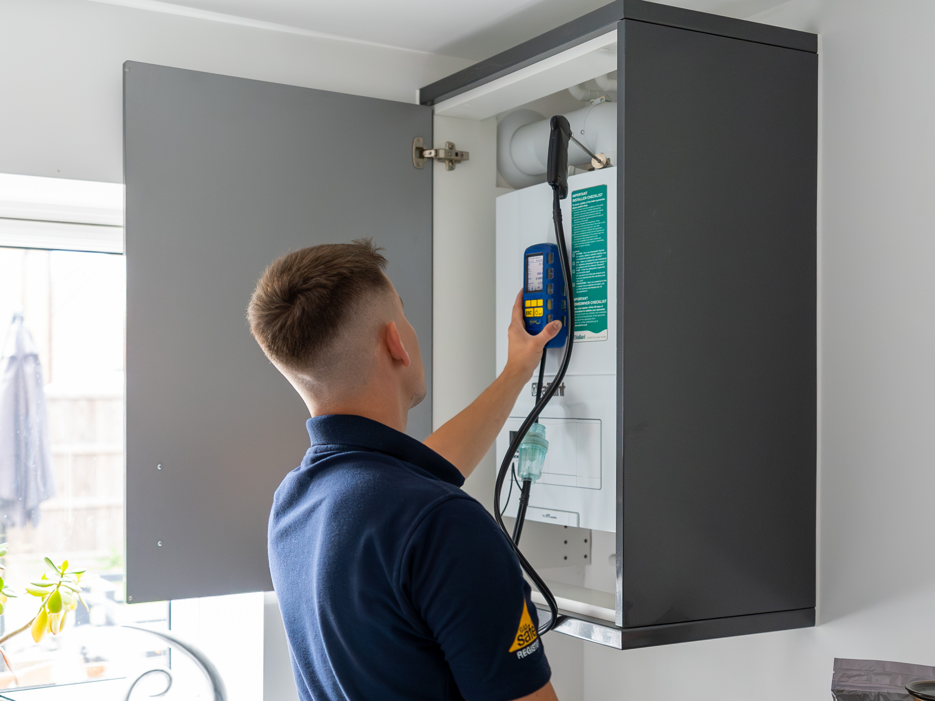 A JPR engineer servicing a boiler in a home